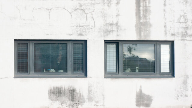 Ventanas en edificio de oficinas con fachada deteriorada