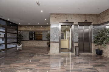 Portal of a residential home with polished granite floors, double stainless steel elevator and...