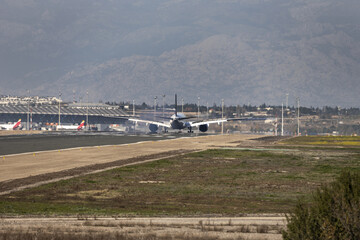 Fototapeta na wymiar A plane landing on a runway at Madrid, Barajas airport