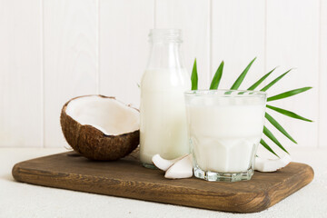 coconut products on white wooden table background. Dairy free milk substitute drink, Flat lay healthy eating
