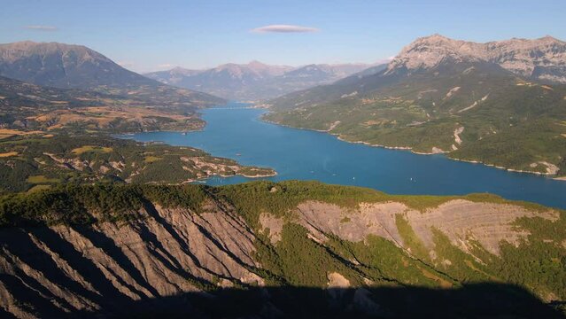 Aerial view of Serre-Poncon lake with Chanteloube Bay, Savines-le-Lac village and Grand Morgon peak. Summer in Durance Valley. Hautes-Alpes (Alps), France