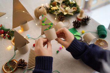 Step-by-step instructions on how to make a Christmas tree out of cardboard. Step 3 Decorate the...