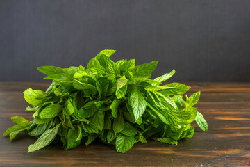 Fresh mint on dark wooden background.