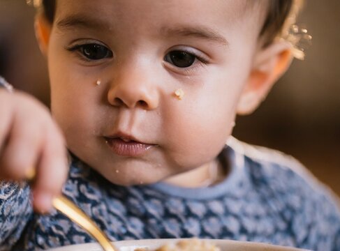 Latin baby eating porridge closeup
