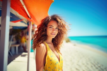 Closeup portrait of a beautiful young woman in summer clothes on the beach