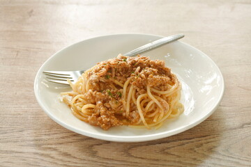 spaghetti dressing fried chop pork and slice tomato in ketchup sauce on plate 