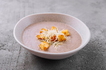 homemade cream soup with croutons and parmesan cheese
