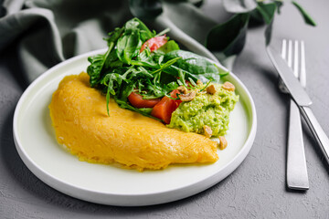 Omelette Served with Avocado puree and Cherry Tomatoes