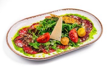 Beef carpaccio with Parmesan and arugula on plate isolated