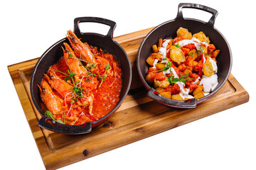 freshly cooked prawns in spicy tomato sauce and fish in batter
