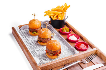 mini burgers with fries on wooden tray