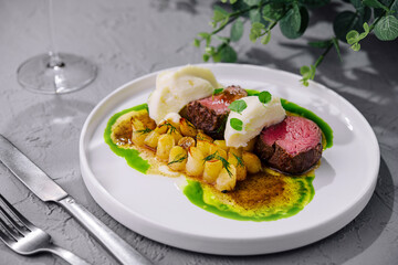 beef medallions with mashed potatoes and celery