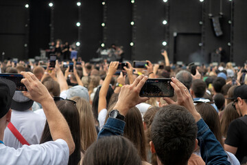 crowd of people at a concert in a huge concert hall