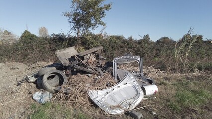 car destroyed and demolished illegally in the countryside by the mafia underworld - environmental...