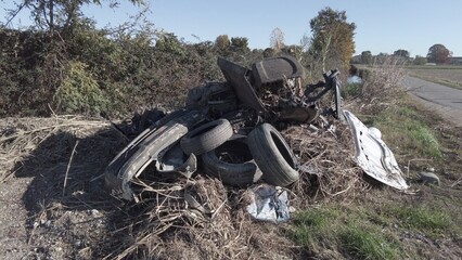 car destroyed and demolished illegally in the countryside by the mafia underworld - environmental pollution and crime against nature and people's health - illegally disposing of dangerous waste