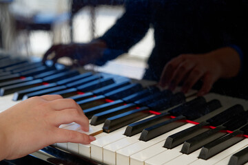 Obraz premium teenager hand on piano keys close-up