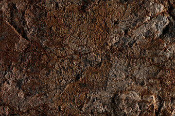 Brown stone texture, dark abstract background. Natural mineral rock close up details, empty backdrop with copy space for design
