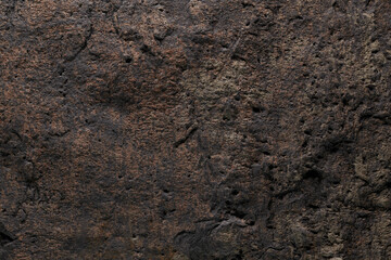 Brown stone texture, dark abstract background. Natural mineral rock close up details, empty backdrop with copy space for design