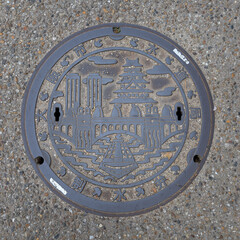 Osaka, Japan - April 4 2023: Design of manhole cover with pattern of Osaka Castle