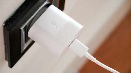 The fast charger socket of the mobile phone is plugged in.