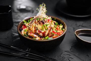 Salad with eel and couscous on black bowl - obrazy, fototapety, plakaty