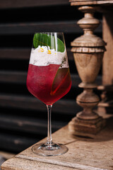 red fresh exotic alcoholic cocktail and pineapple leaf