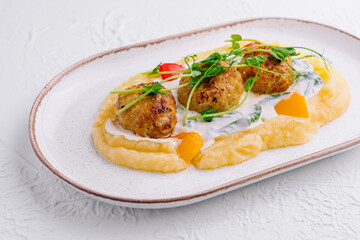 Meatballs with mashed potatoes on white plate