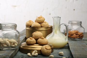 Cashew Cookies, cookies with the main ingredients cashews on wooden surface with white background. High Resolution