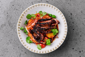 Grilled octopus with vegetables on top view