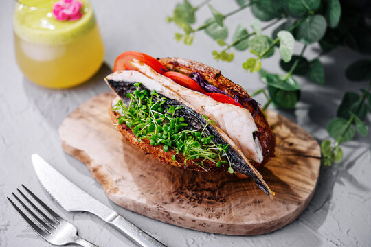 Mackerel fish sandwich on wooden board