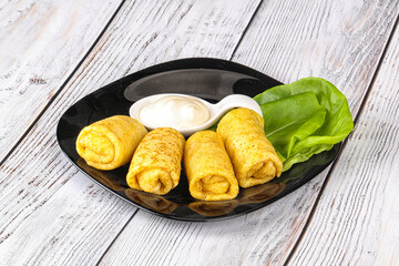 Stuffed pancakes with cream sauce