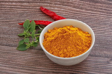 Yellow vibrant curcuma powder in the bowl