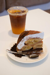 Banoffee cake with bananas and whipped cream in cafe restaurant
