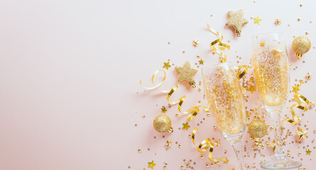 Happy New year celebration background concept. Champagne glass , golden ribbon, stars and christmas ball on pastel background.