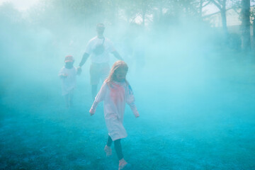 Family celebrating Holi with powder colors or gulal.