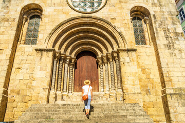 Fototapeta na wymiar Woman visiting a church, Coimbra, Igreja de Sao Tiago