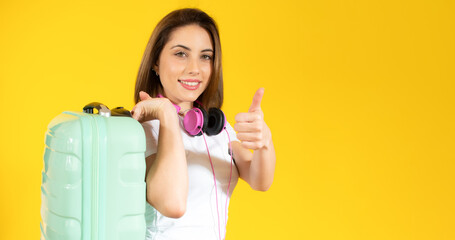 Traveler woman wear summer casual clothes hold suitcase isolated on plain pastel yellow color background studio. Tourist travel abroad in free spare time rest getaway. Air flight trip journey concept