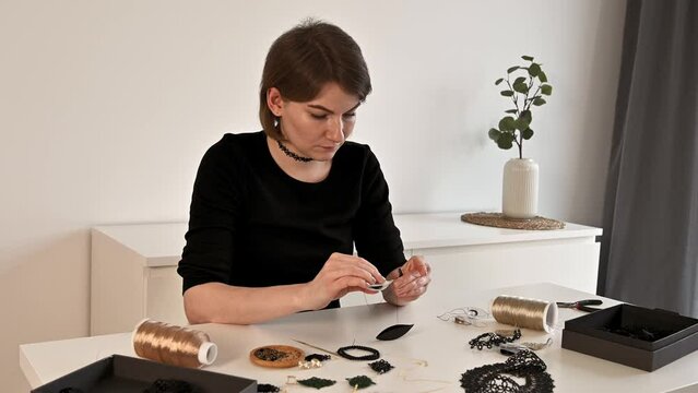 woman tatting jewllery. Hobby or small business creative concept