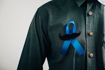 Men's hands exhibit a Blue Ribbon with a moustache, signifying solidarity and support for Colon...
