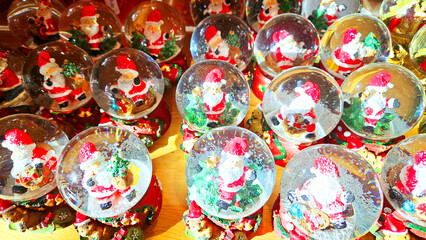 Christmas glass balls with snow and Santa Claus inside. waiting for Christmas