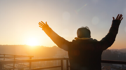 Human hands open palm up worship on sunset background.