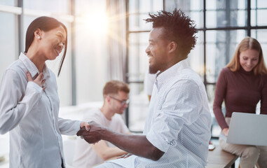 Obraz premium Business Handshake - business people shaking hands. Handshake between business man and woman indoors.