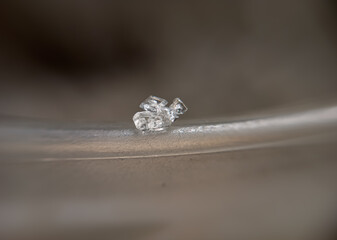 close up, macro photo, some sugar crystals
white on the surface of the glass with a blurry background
