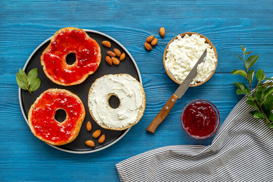 Set of fresh bread bagels with with berry jam and cheese cream. Healthy breakfast