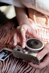 Close view of a girl holding a retro camera