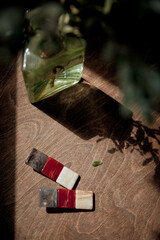 A close-up of fashion hair clips lying on a wooden table near a flower vase
