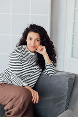 Fototapeta premium Portrait of a beautiful young woman with black curly hair