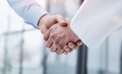 Partners or lawyers shaking hands at a meeting. Teamwork, partnership, success concept.