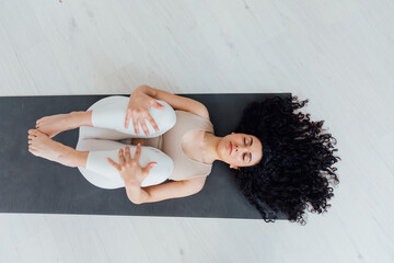 Beautiful woman doing exercises yoga asana gymnastics
