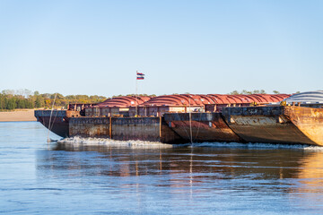 Close up of the bow of freight barges on the calm waters of the Mississippi river during low water...